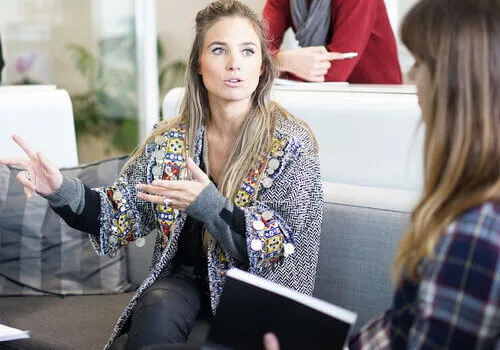 A woman leading a discussion with a colleague